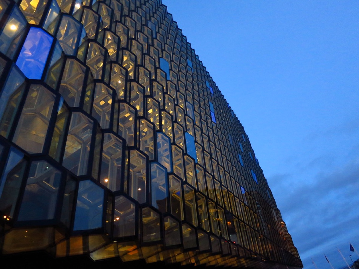 Exterior view of Harpa Concert Hall in Reykjavik, Iceland, with modern architecture reflecting the city's artistic heritage