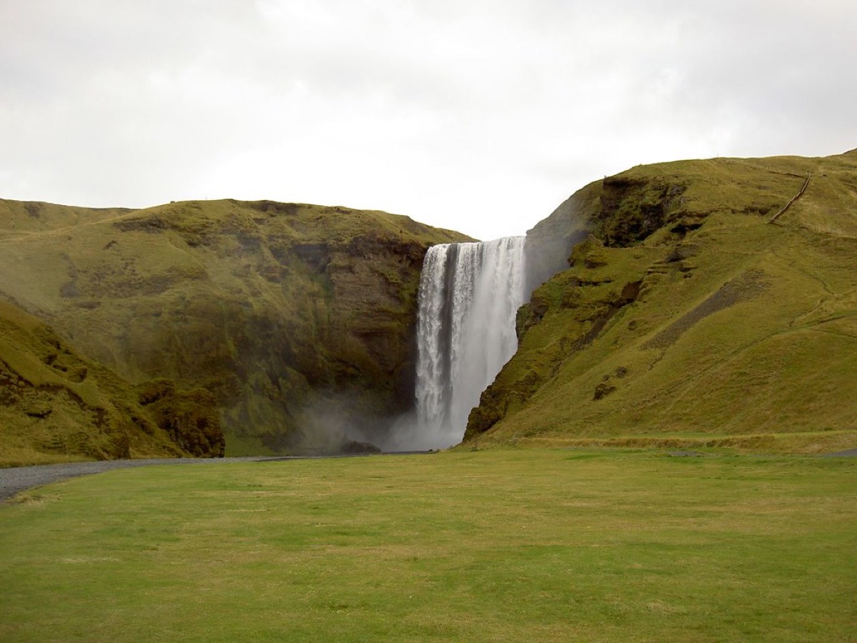 Icelandic waterfall trail with natural stones and a small stream