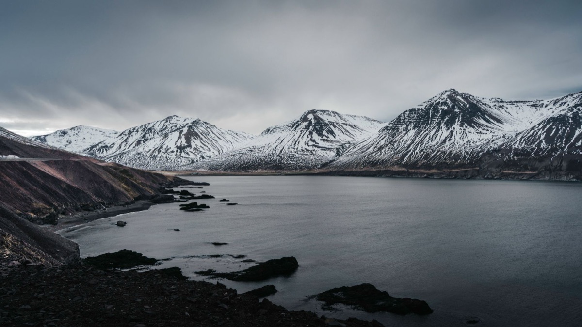 Icelandic snow-covered mountain range at night